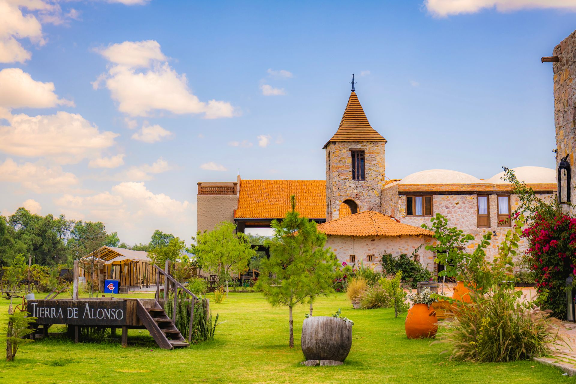 Picturesque vineyard landscape with a rustic building under a vibrant sky in Querétaro, Mexico.