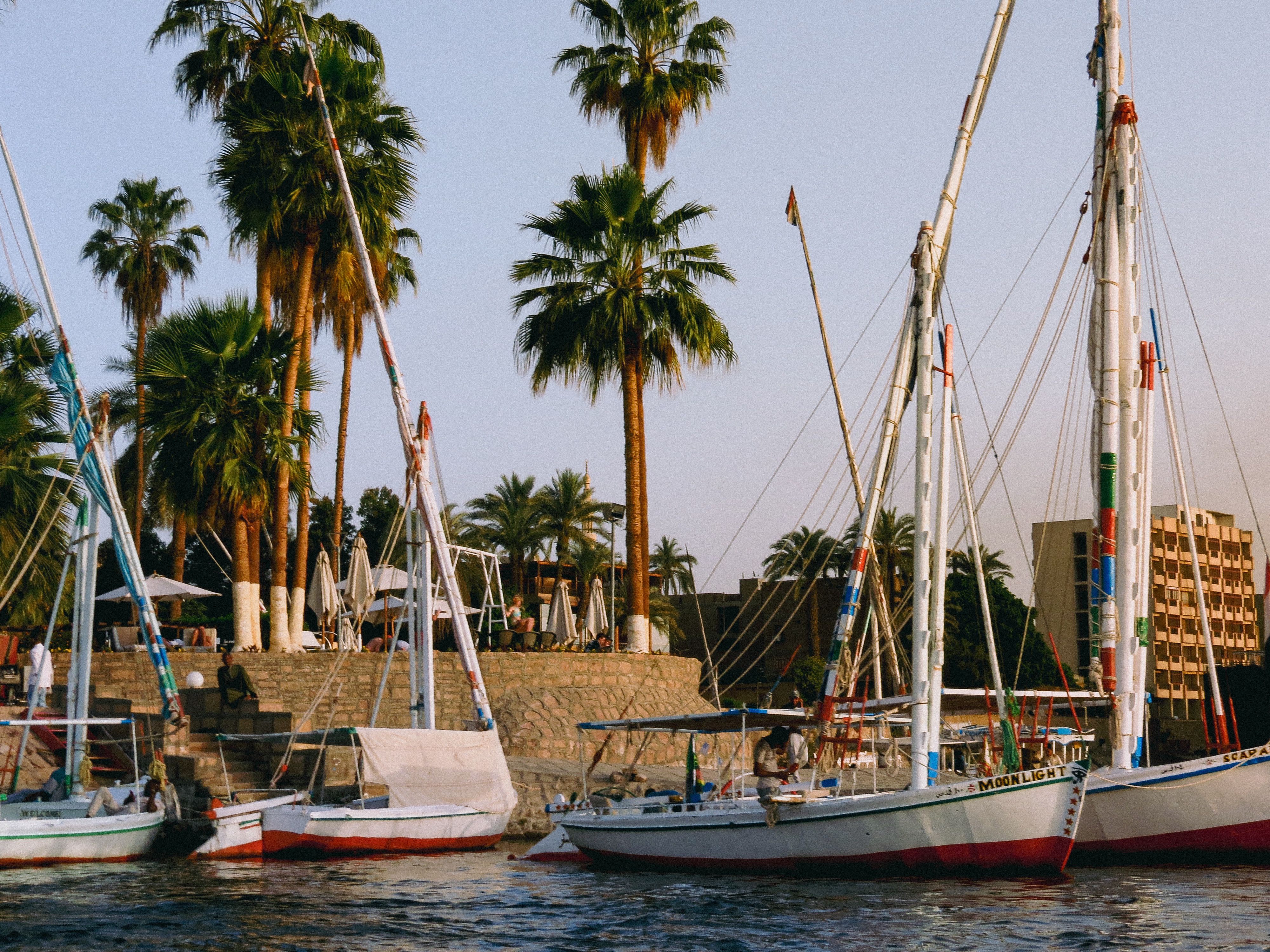 Corniche promenade with feluccas moored at dusk