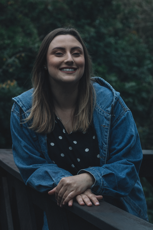 Smiling Woman on a Bridge in Sunlit Forest · Free Stock Photo