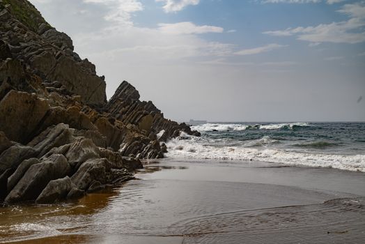Explore the stunning rocky coastline of País Vasco with dramatic cliffs and crashing waves.