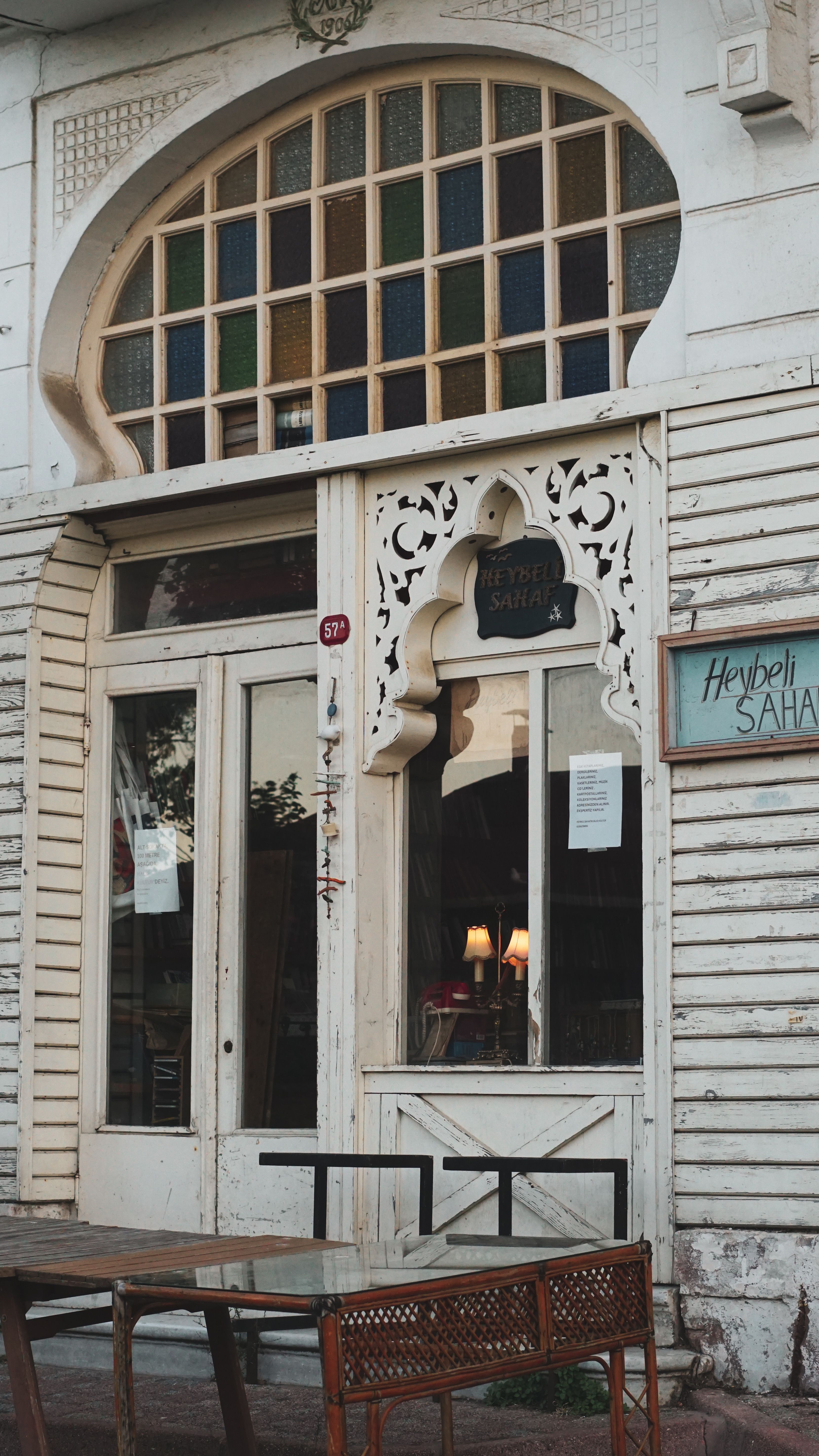 Charming vintage cafe exterior with classic design and stained glass windows.