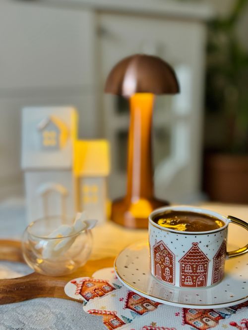 Free Warm cup of coffee in a cozy indoor setting with soft lighting and decorative elements. Stock Photo