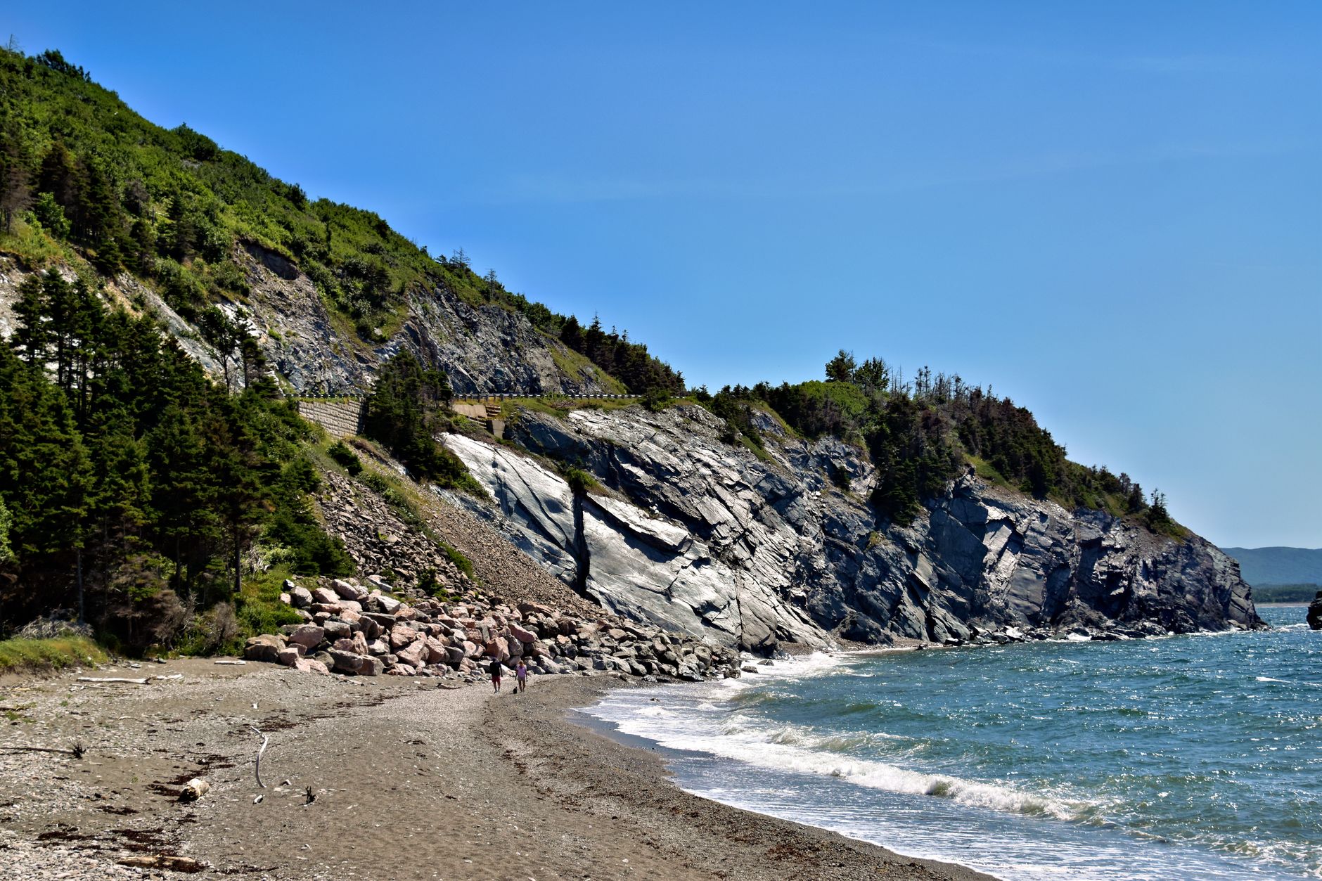 Stunning coastal landscape with rocky cliffs and ocean waves in Cape Breton, Nova Scotia.