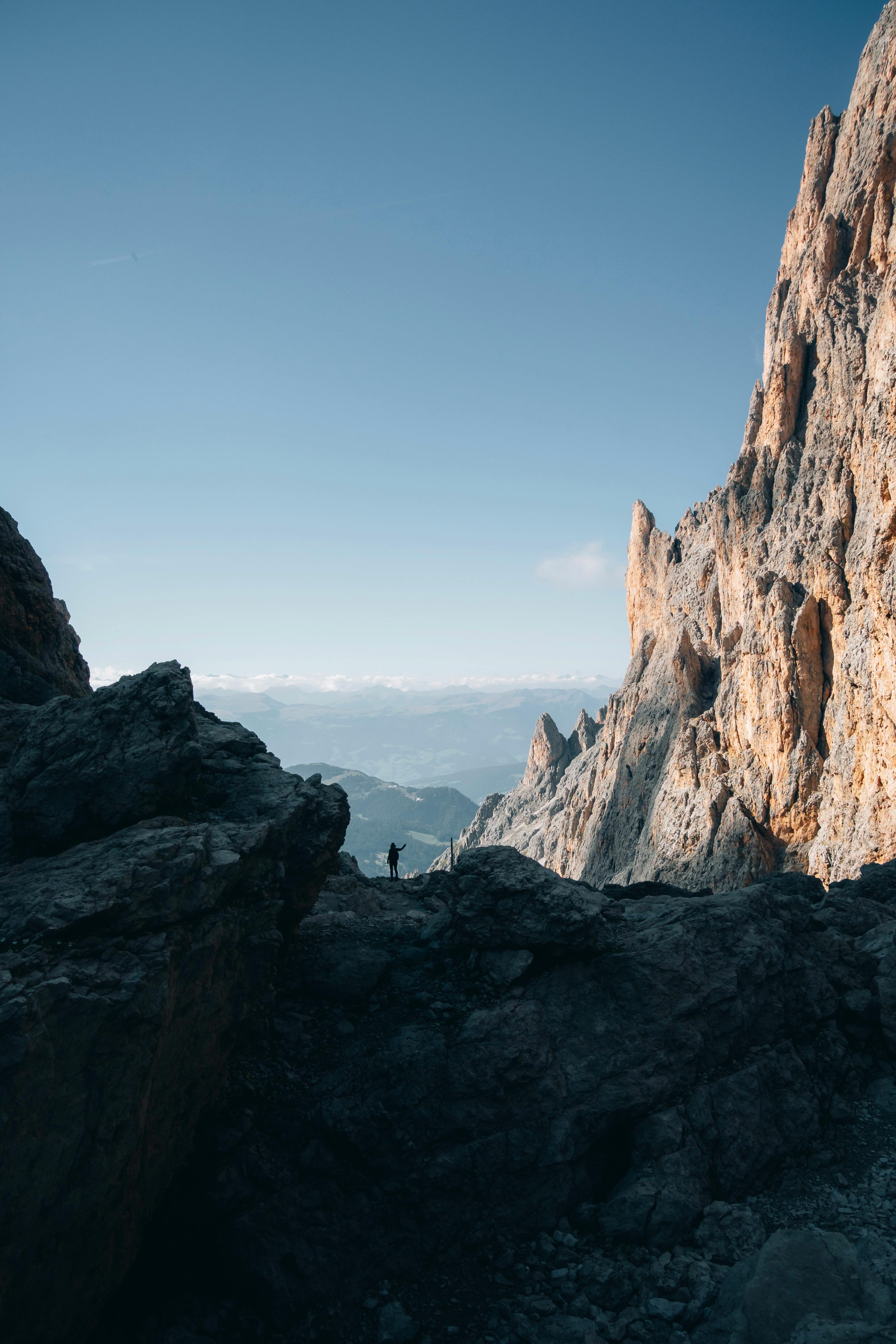 A lone adventurer hikes through rugged landscapes of the Dolomites, Trentino-Südtirol, Italy.