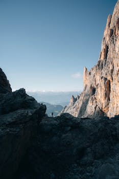 A lone adventurer hikes through rugged landscapes of the Dolomites, Trentino-Südtirol, Italy.