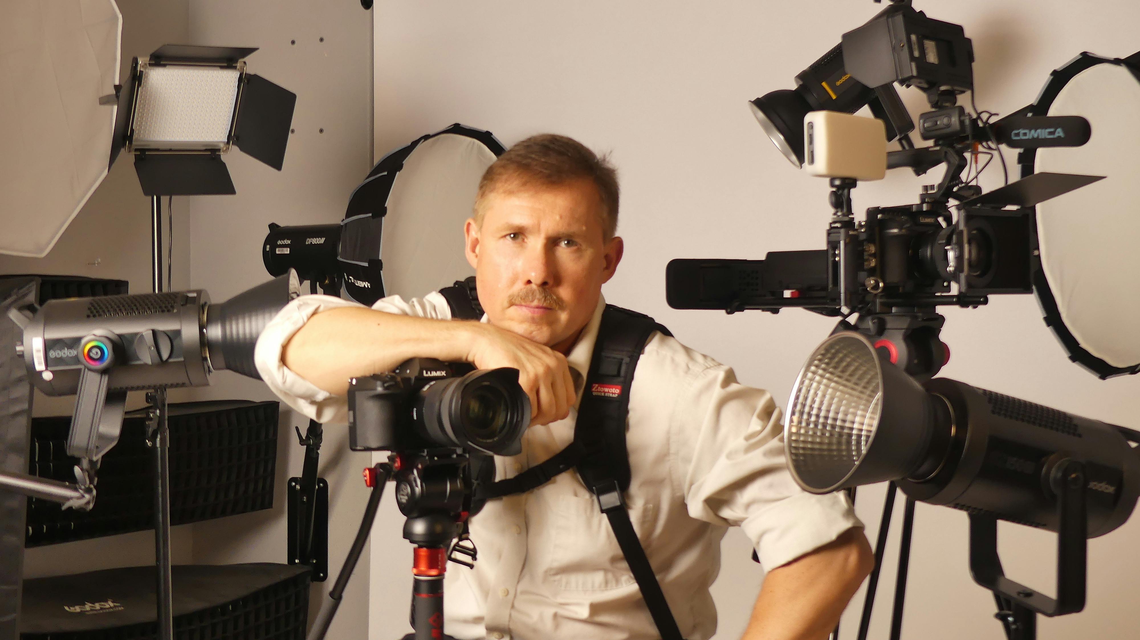Professional Photographer in Studio with Equipment · Free Stock Photo, image size:1260x707