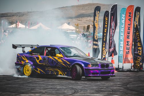 Free Vibrant sports car drifts amidst smoke at an auto show in Ankara, Türkiye. Stock Photo