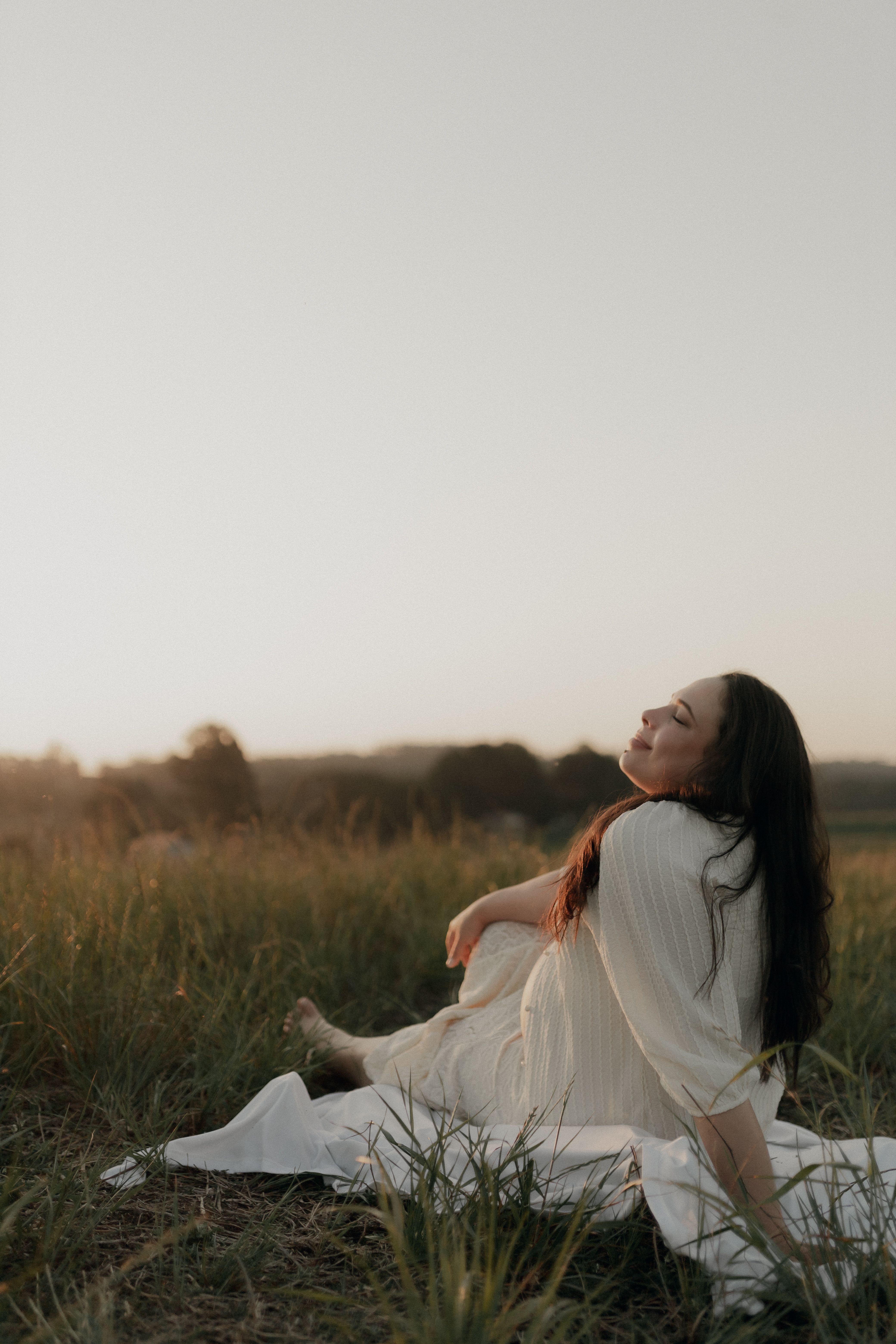 Girl in White Dress Sitting on Green Grass Field · Free Stock Photo