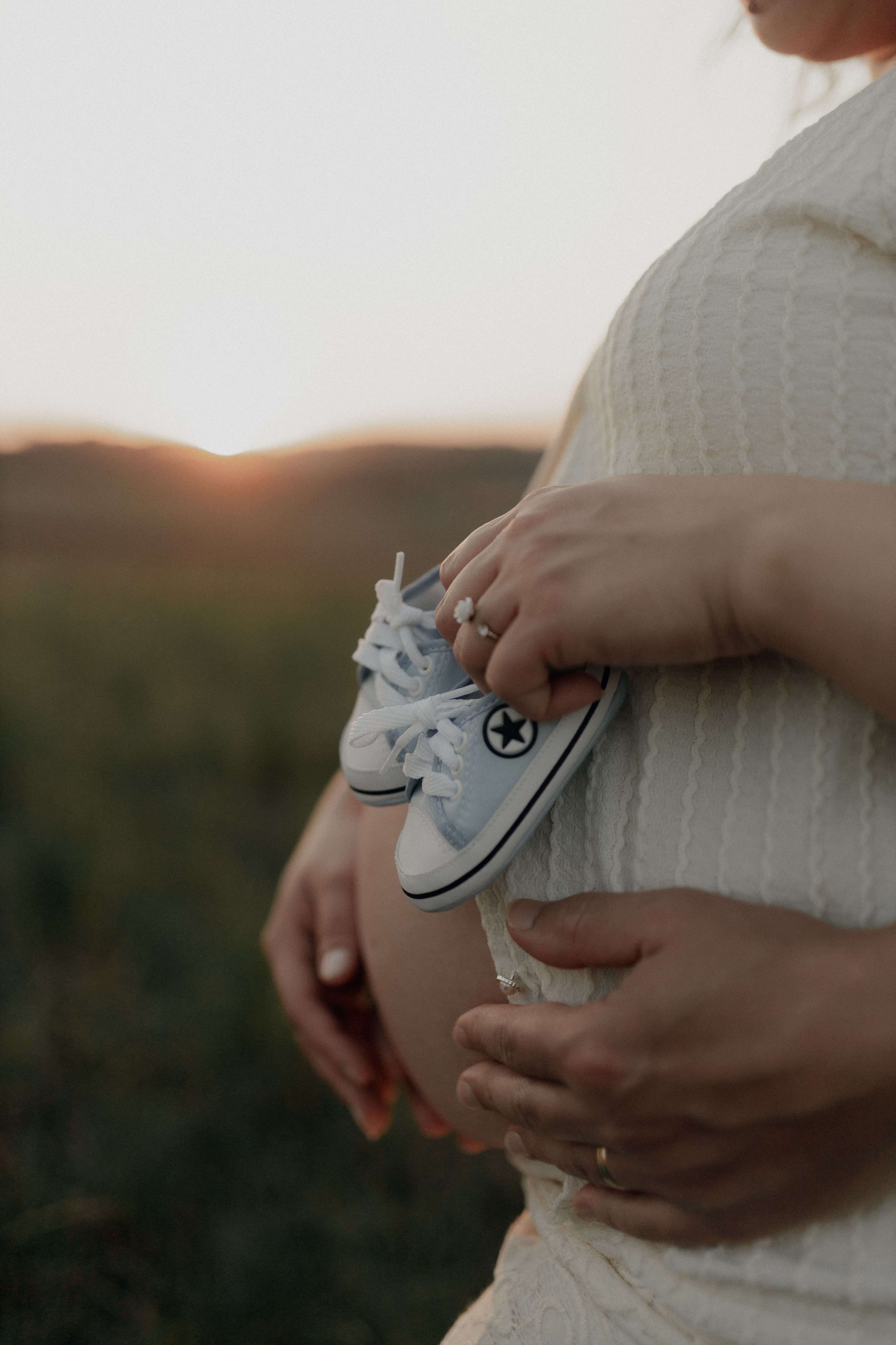 Woman Hugging Man in Cap and Holding Baby Shoes and USG Pictures · Free ...