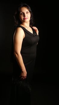 Elegant portrait of a woman in a black dress with dramatic lighting.