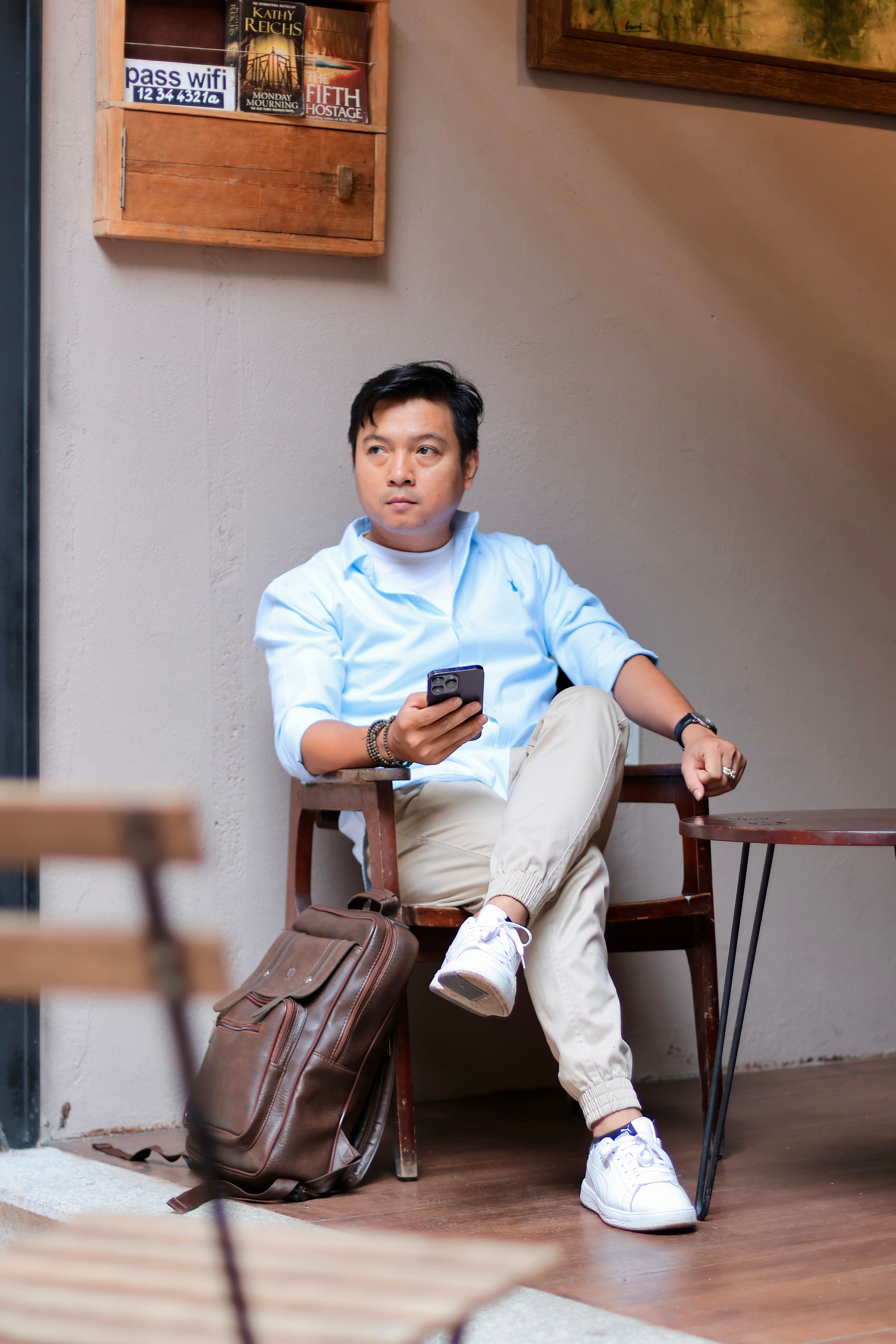 Relaxed man with backpack in trendy cafe setting