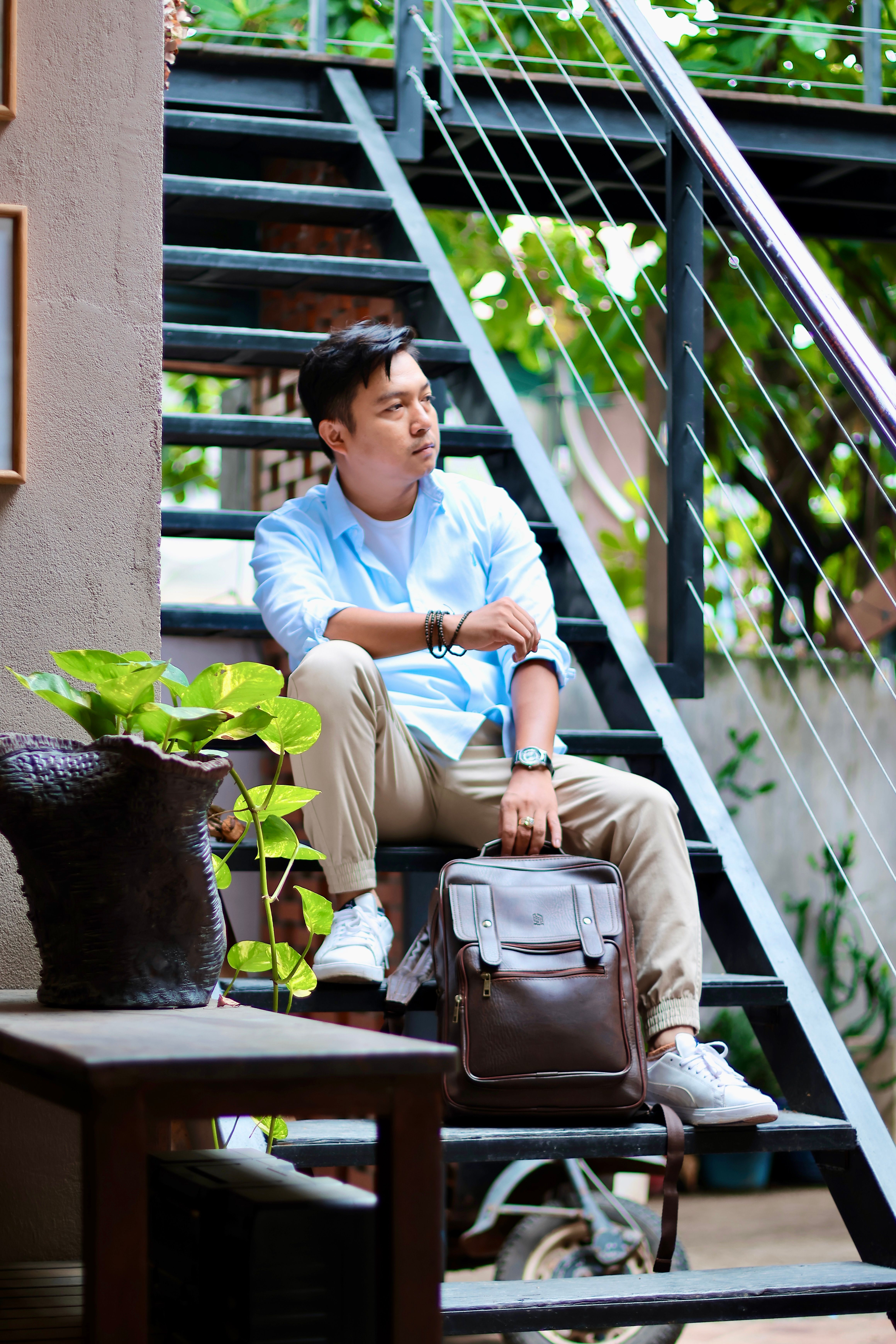 Casual Young Man Sitting on Outdoor Stairs