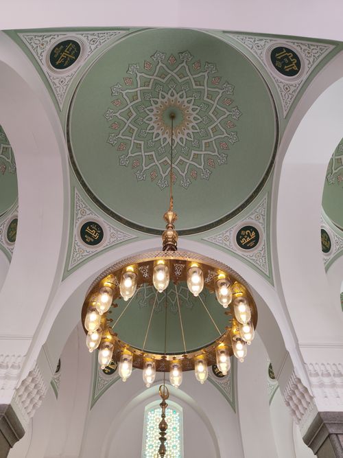 Free Stunning view of an ornate ceiling and chandelier in a historic mosque in Madinah, Saudi Arabia. Stock Photo
