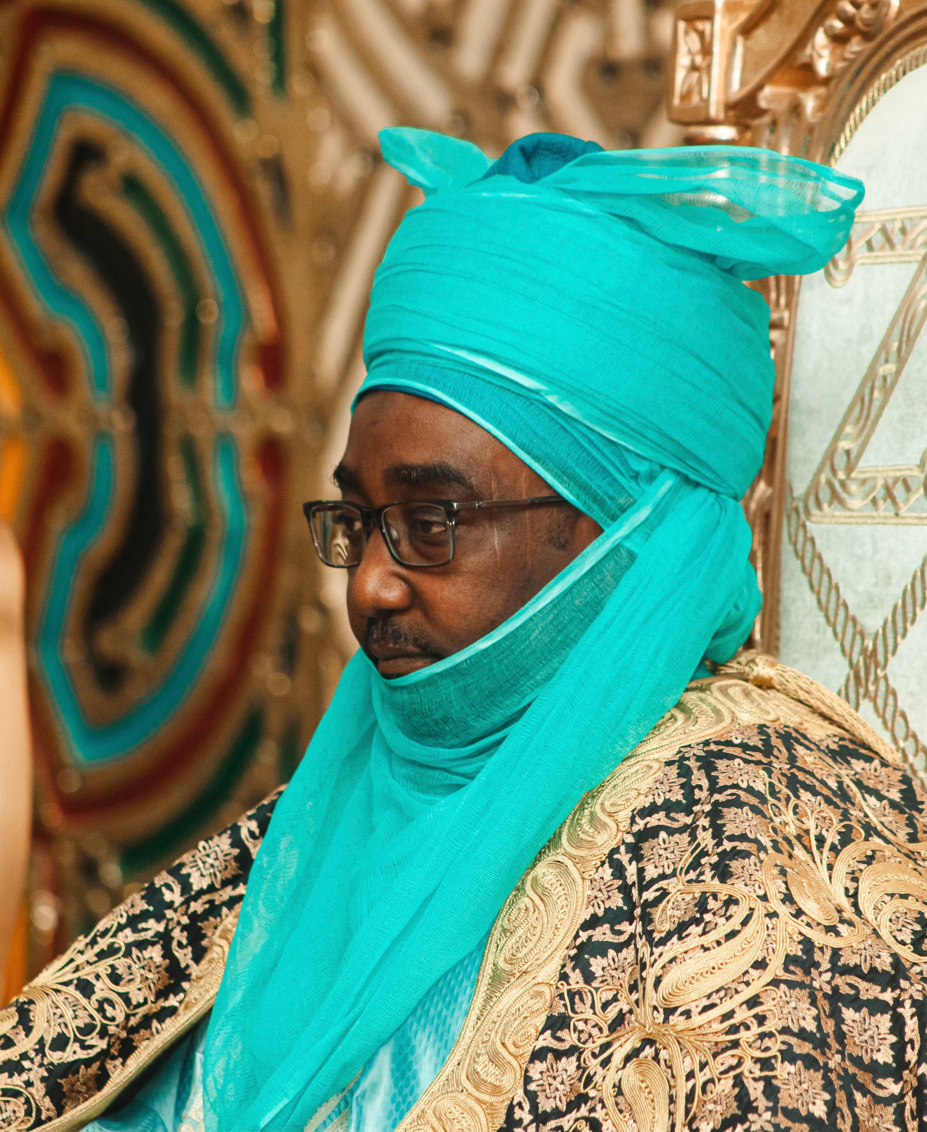 Elegant portrait depicting traditional African attire and cultural richness, highlighting intricate design and color.
