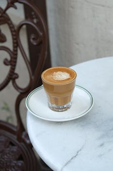 A stylish cortado served on a classic marble table in an Istanbul café, offering a taste of Turkish coffee culture.