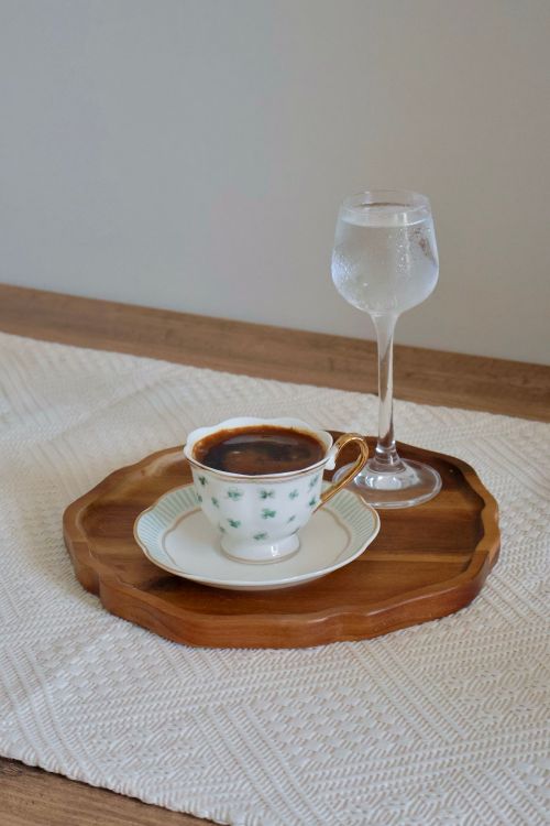 Free A stylish coffee with water served on a wooden tray in a decorative setting. Stock Photo