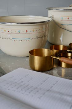 Charming vintage kitchenware with measuring cups and recipe notes.