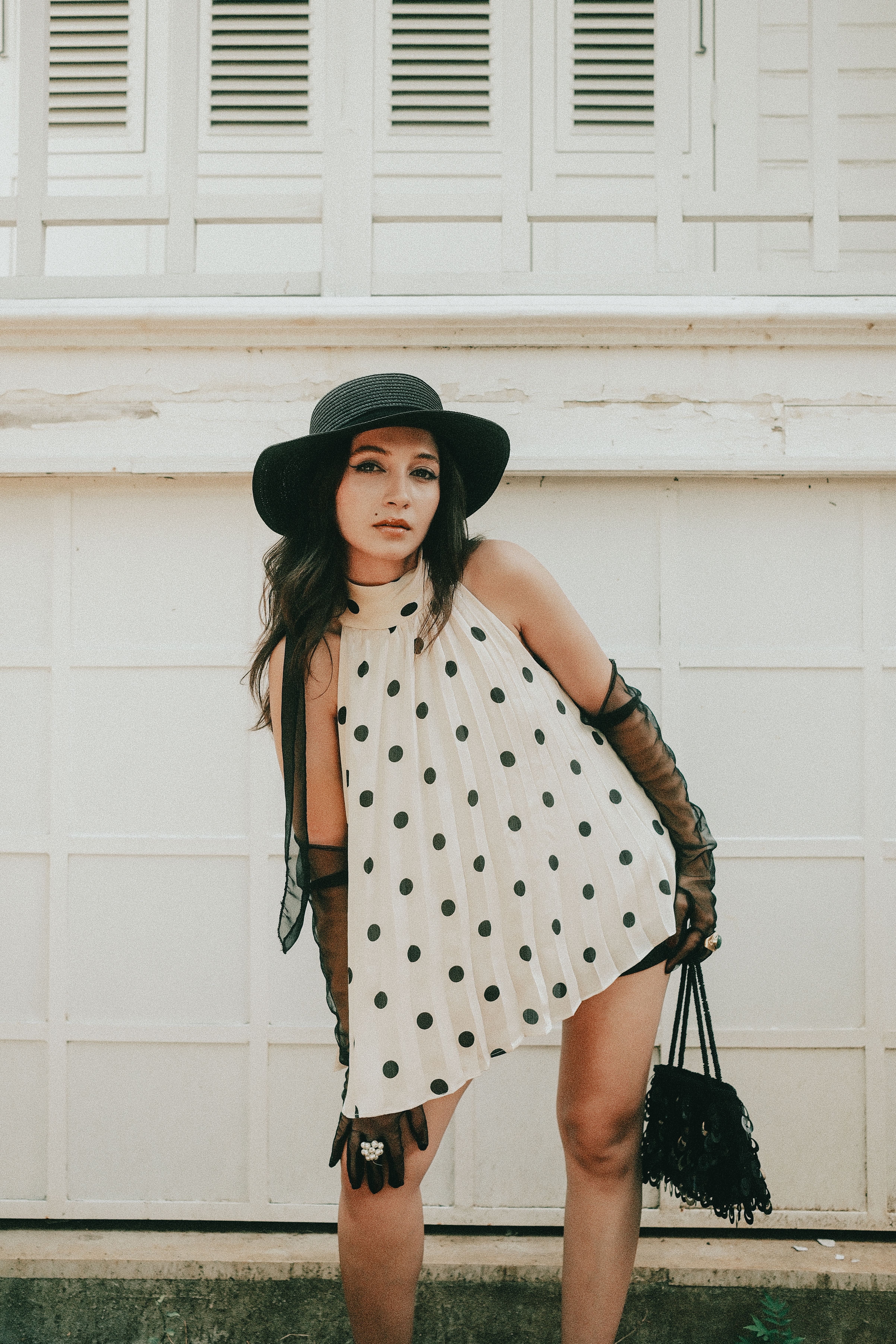Chic Woman in Polka Dot Dress Posing Outdoors · Free Stock Photo