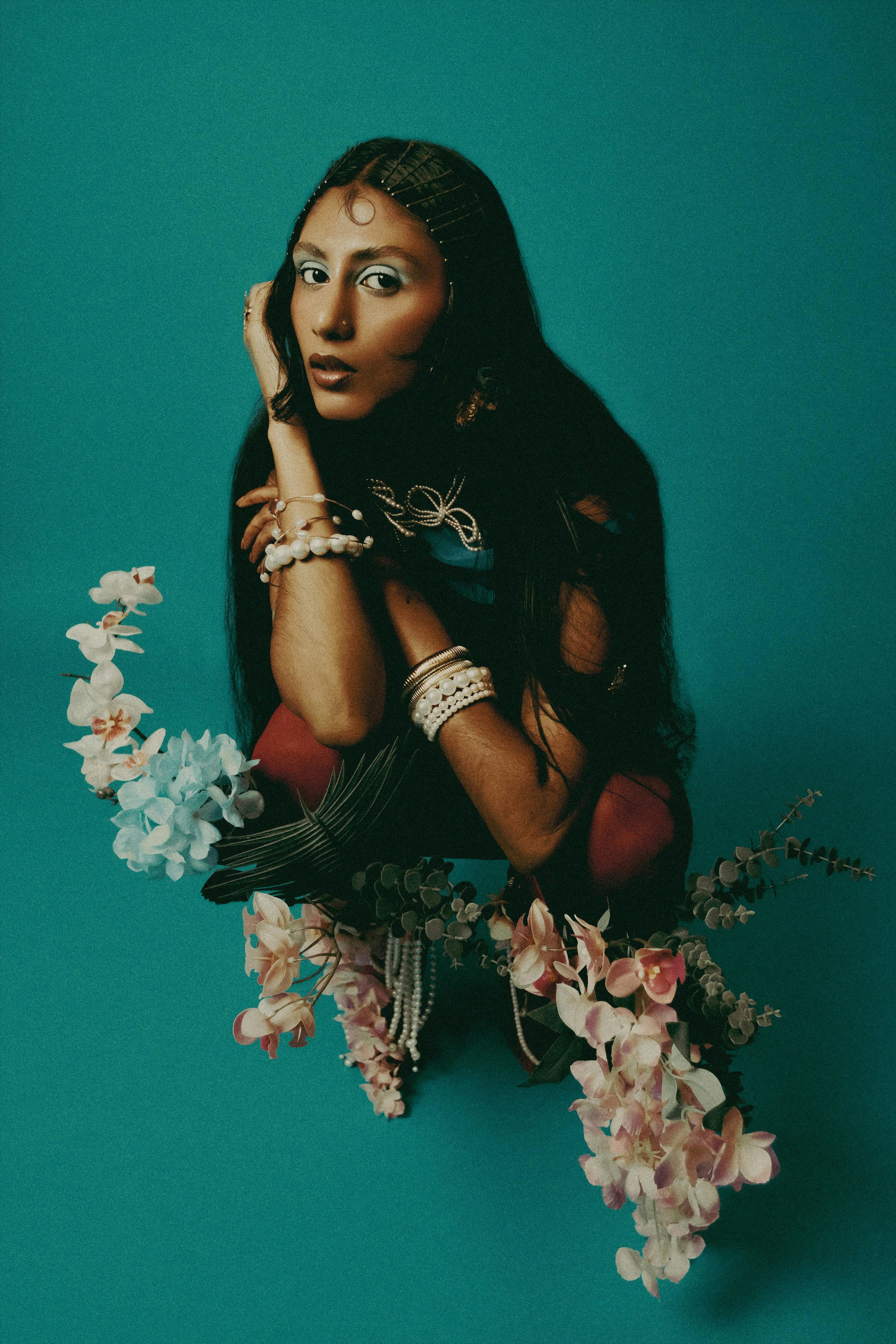 Portrait of a stylish woman with floral elements, emphasizing elegance and fashion.