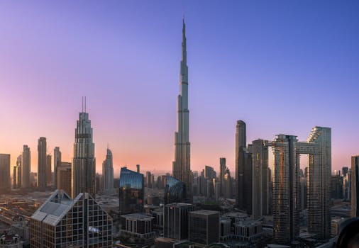The iconic Burj Khalifa rises majestically over Dubai's modern skyline at sunrise.