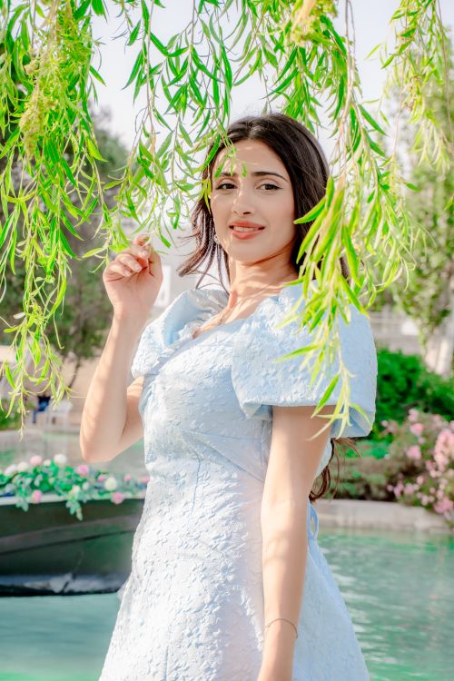 Free Sophisticated woman in blue dress by water in Baku, showcasing elegance and style. Stock Photo