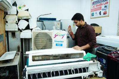 AC repair technician at work
