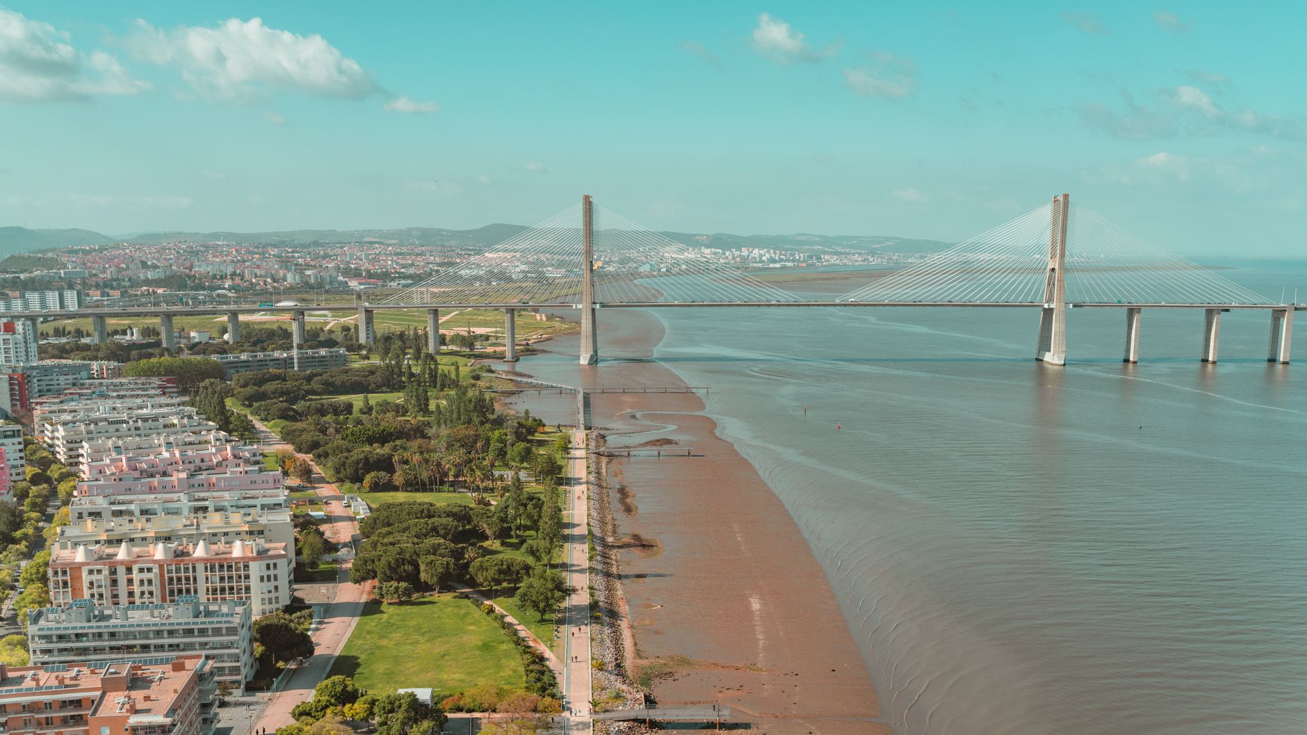 A stunning aerial shot of the Vasco da Gama Bridge and surrounding landscape in Lisbon, Portugal.