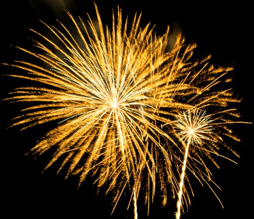 Free A vibrant display of golden fireworks illuminating the night sky, perfect for celebrations. Stock Photo