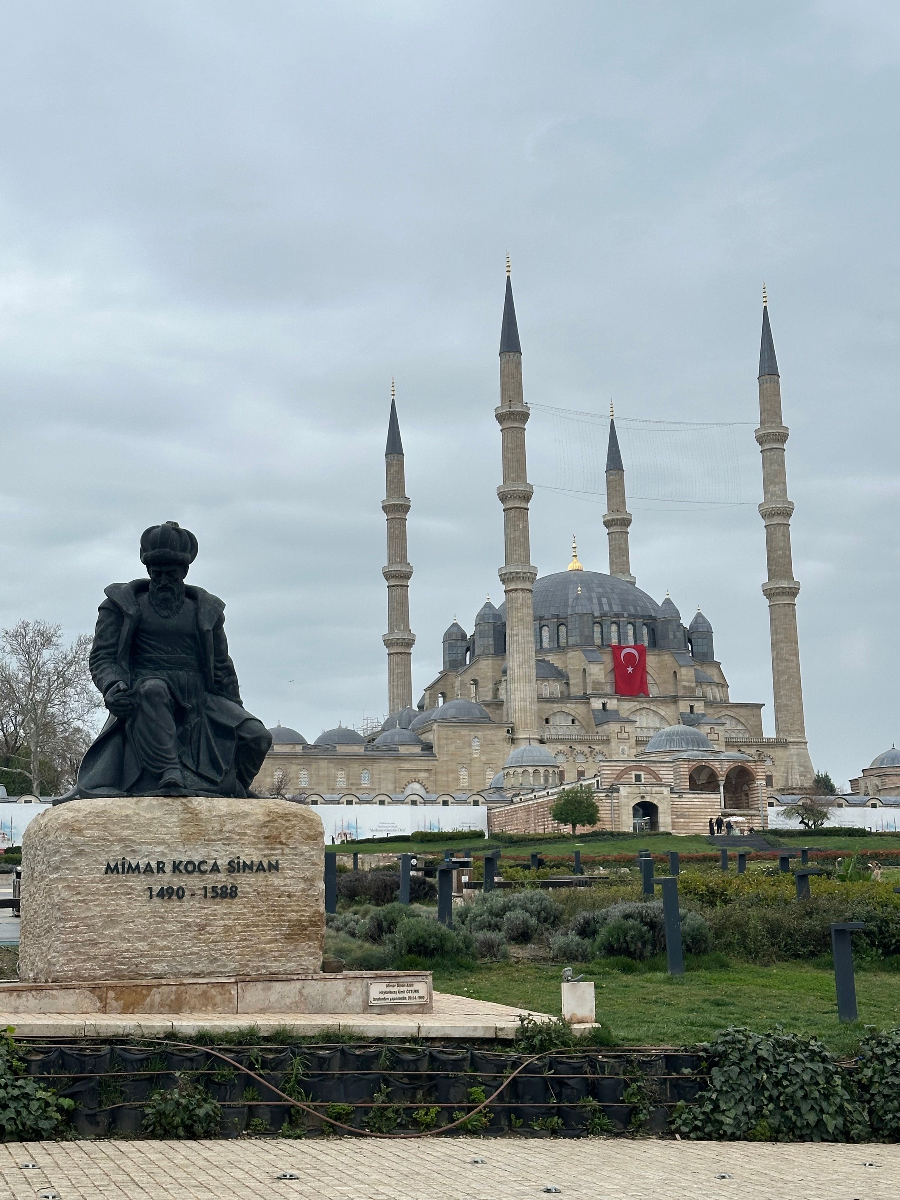 View of the iconic Selimiye Mosque and Mimar Sinan statue in Edirne, Turkey.