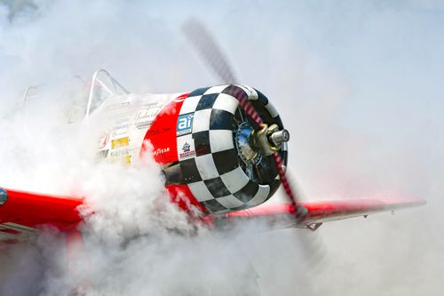 Free A T-6 Texan propeller airplane surrounded by smoke during takeoff in Titusville, Florida. Stock Photo