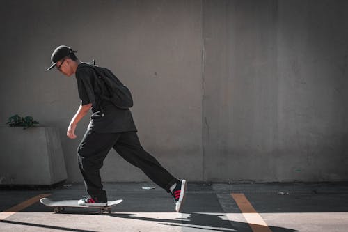 Photo Of Man Riding Skateboard