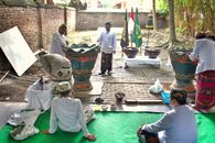 An Indonesian traditional ritual ceremony taking place outdoors in Jawa Barat with participants in cultural attire.
