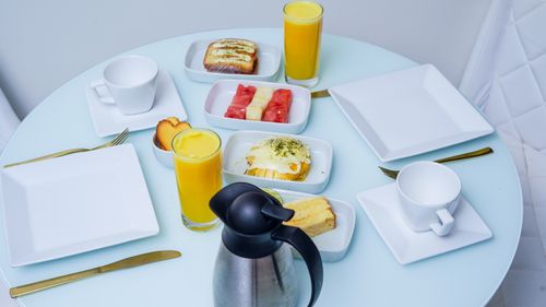 Free A stylish breakfast table with fresh fruit, pastries, and juice, captured in a modern setting. Stock Photo