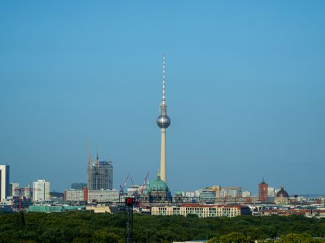 A stunning view of Berlin's TV Tower against the clear blue sky, capturing modern and classic architecture.