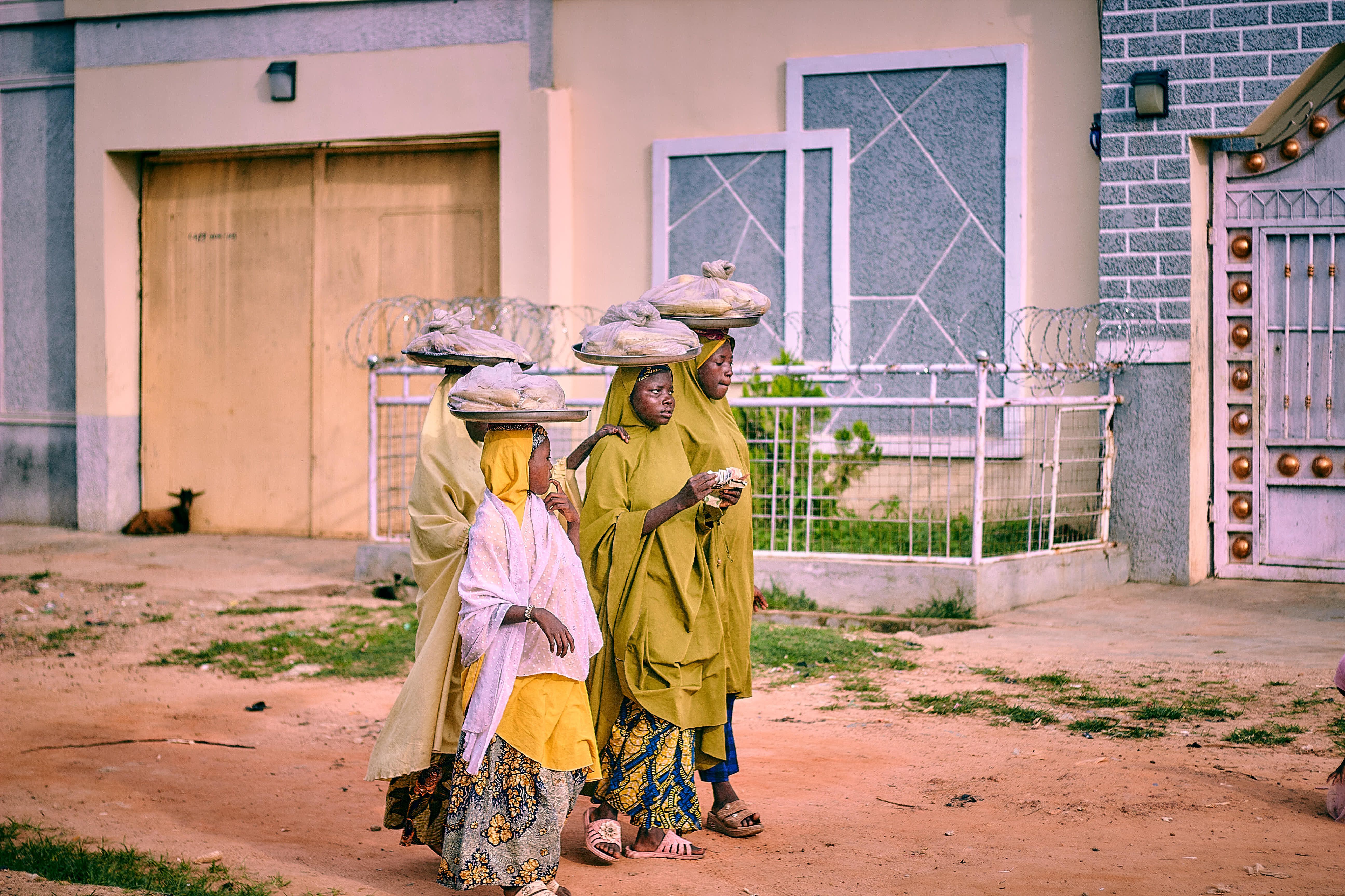 Families walking into a modern church building in Barracks Newtown, Nigeria