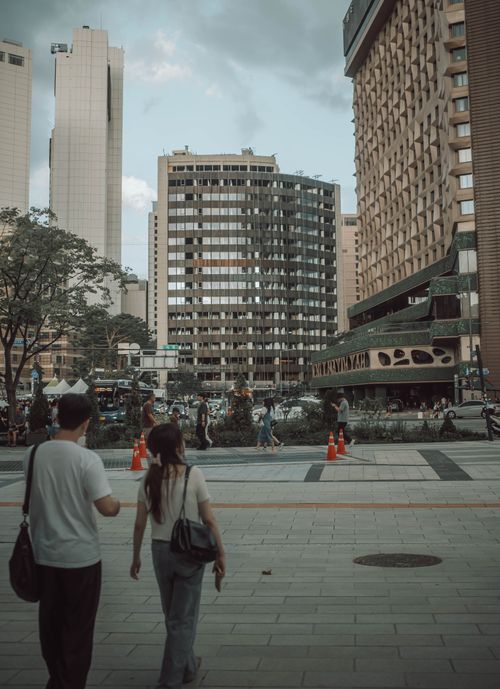 Free Street view of downtown Seoul with diverse people and modern buildings on a sunny day. Stock Photo