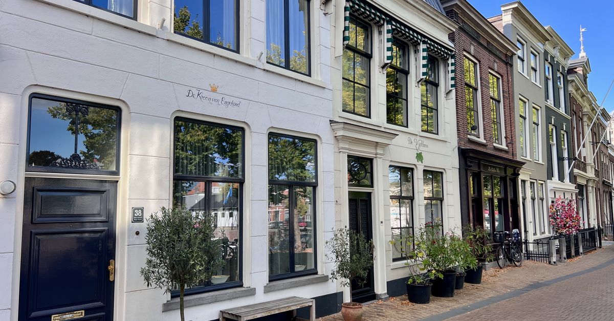 Picturesque Amsterdam street showcasing historic Dutch architecture in bright daylight.