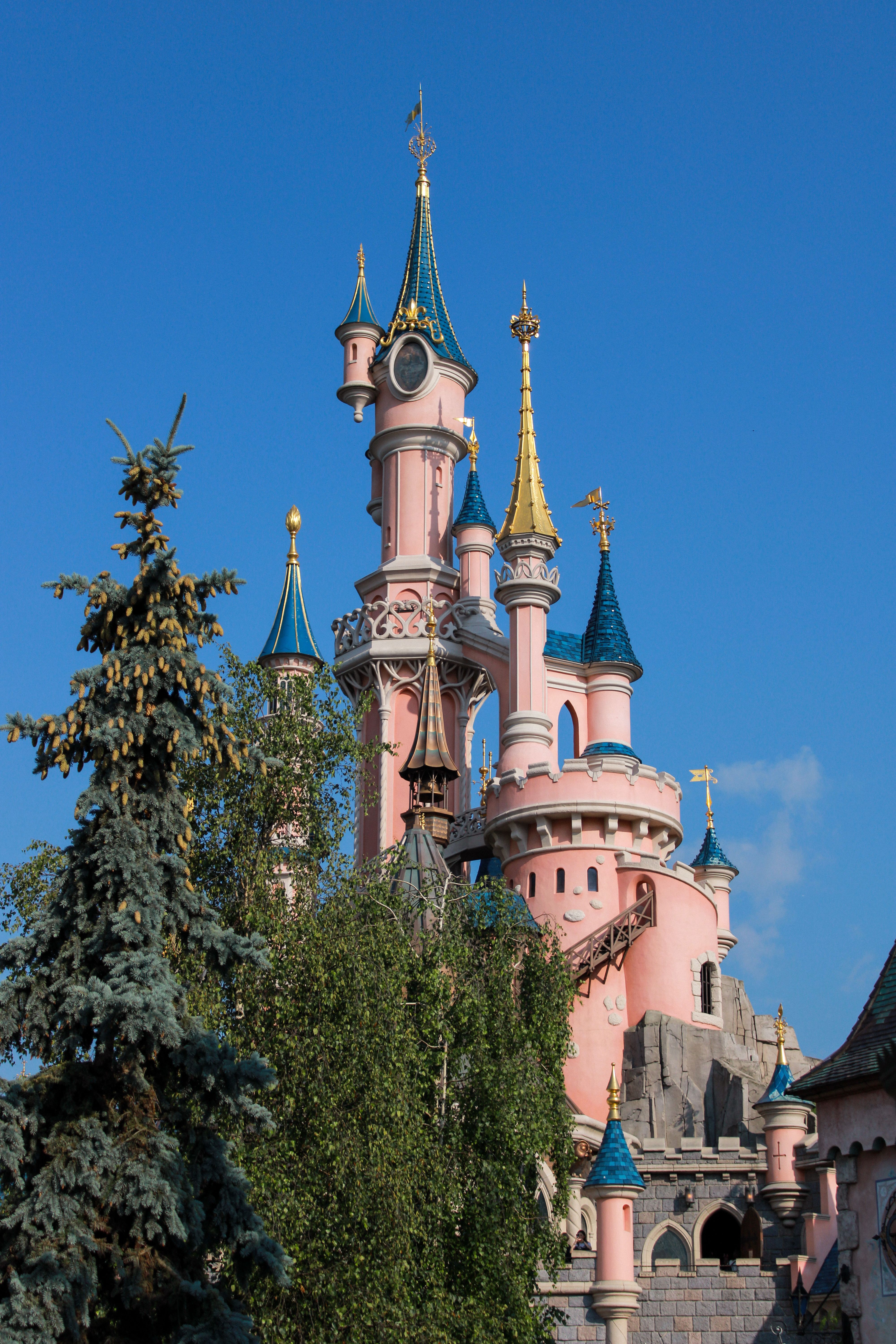 The Sleeping Beauty Castle at Disneyland Paris, a magical fairytale landmark against a clear blue sky.