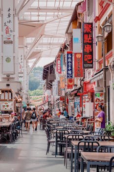 Vibrant street scene in Singapore's Chinatown featuring rows of food stalls with lively atmosphere.