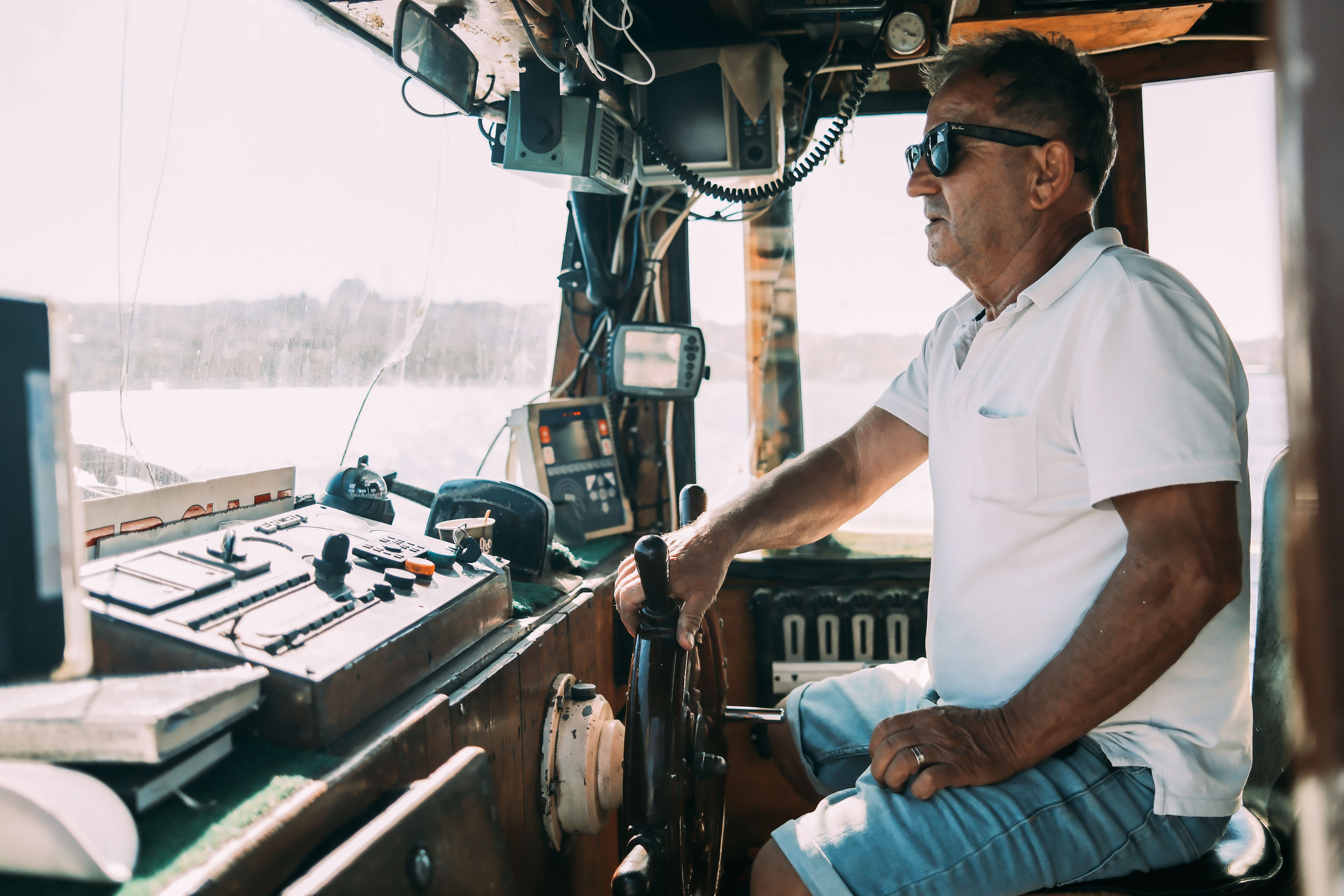 Experienced Captain Navigating the Boat · Free Stock Photo