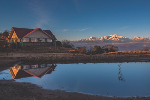 Free Beautiful landscape of Singalila Forest featuring Kanchenjunga mountains and serene reflections. Stock Photo