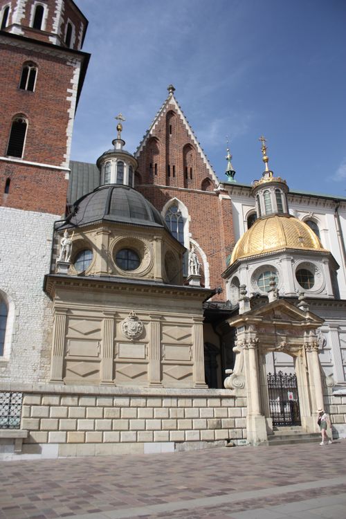 Free Ornate domes and brickwork of Wawel Castle in Kraków, Poland, under clear skies. Stock Photo