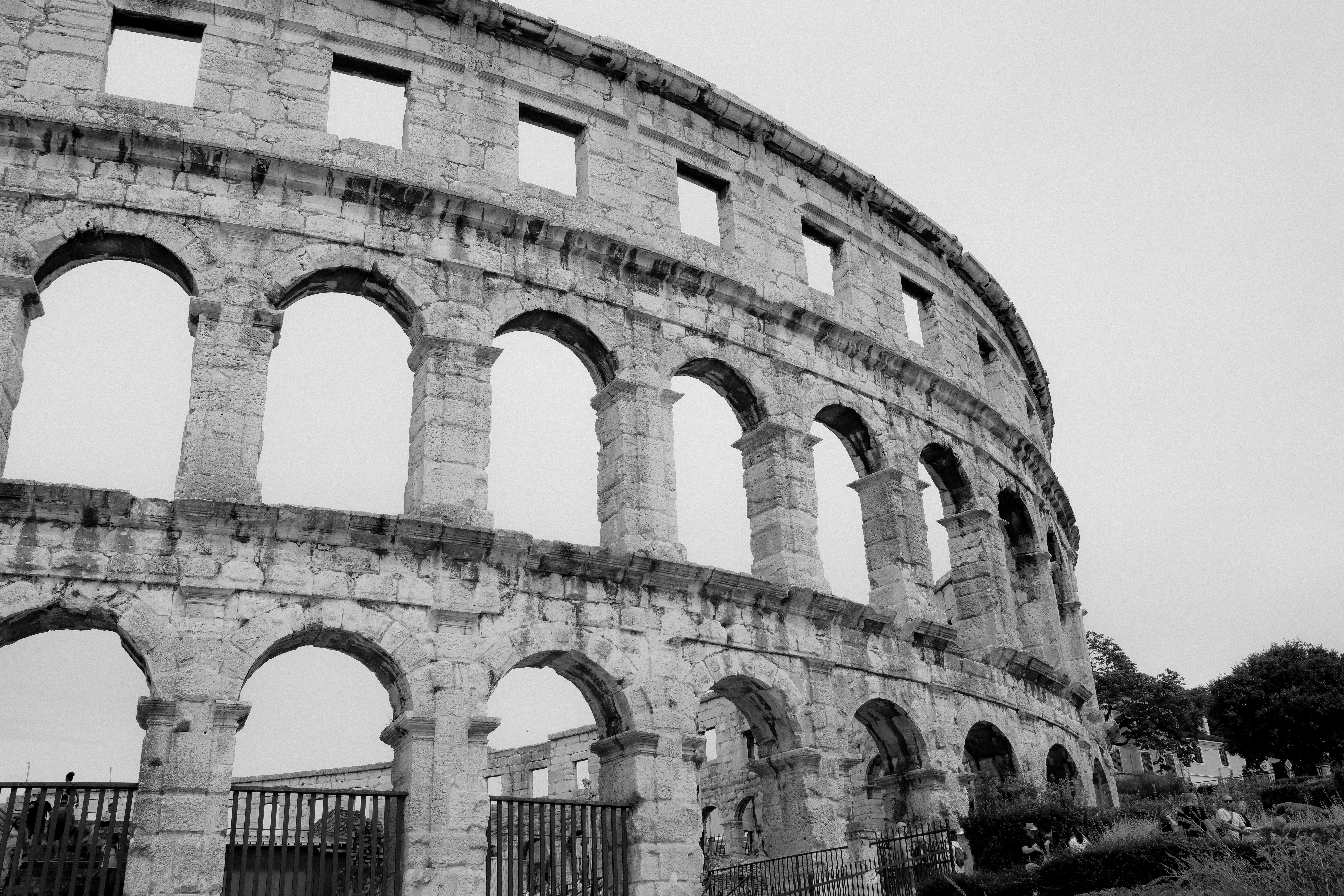 Black and white photo of the ancient Roman amphitheater in Pula, Croatia.