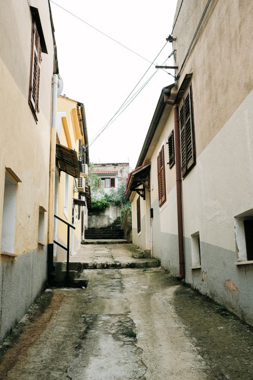Free Explore the charm of a narrow alley in a historic Croatian village, rich with character and culture. Stock Photo