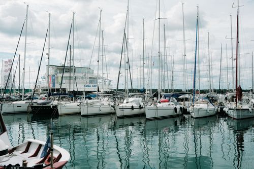 Free Yachts docked at a marina in Croatia on a cloudy day, reflecting in calm waters. Stock Photo