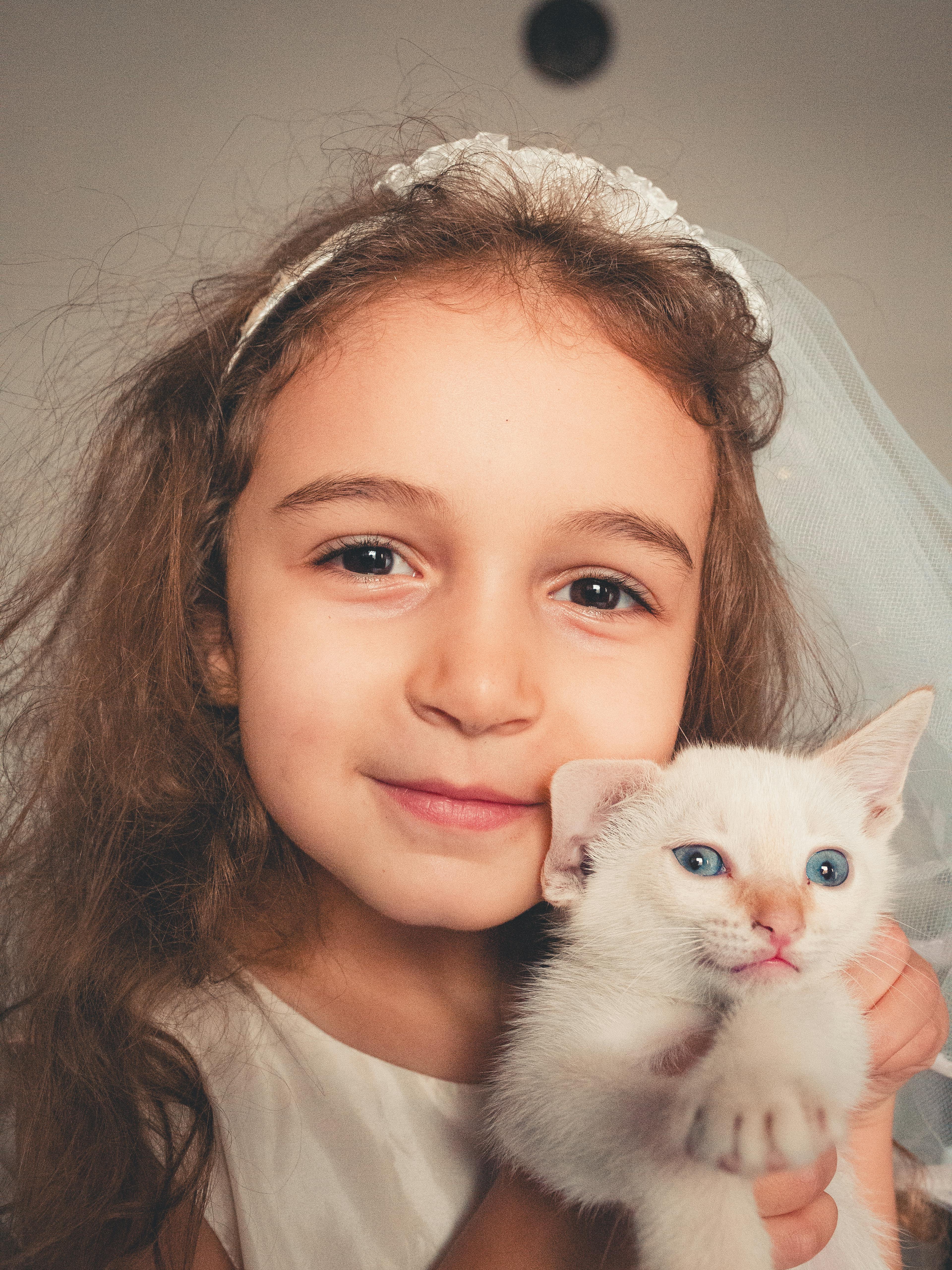 Girl Holding White Kitten
