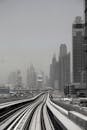 雾天拍摄的迪拜天际线与地铁轨道，呈现出一幅醒目的单色视图