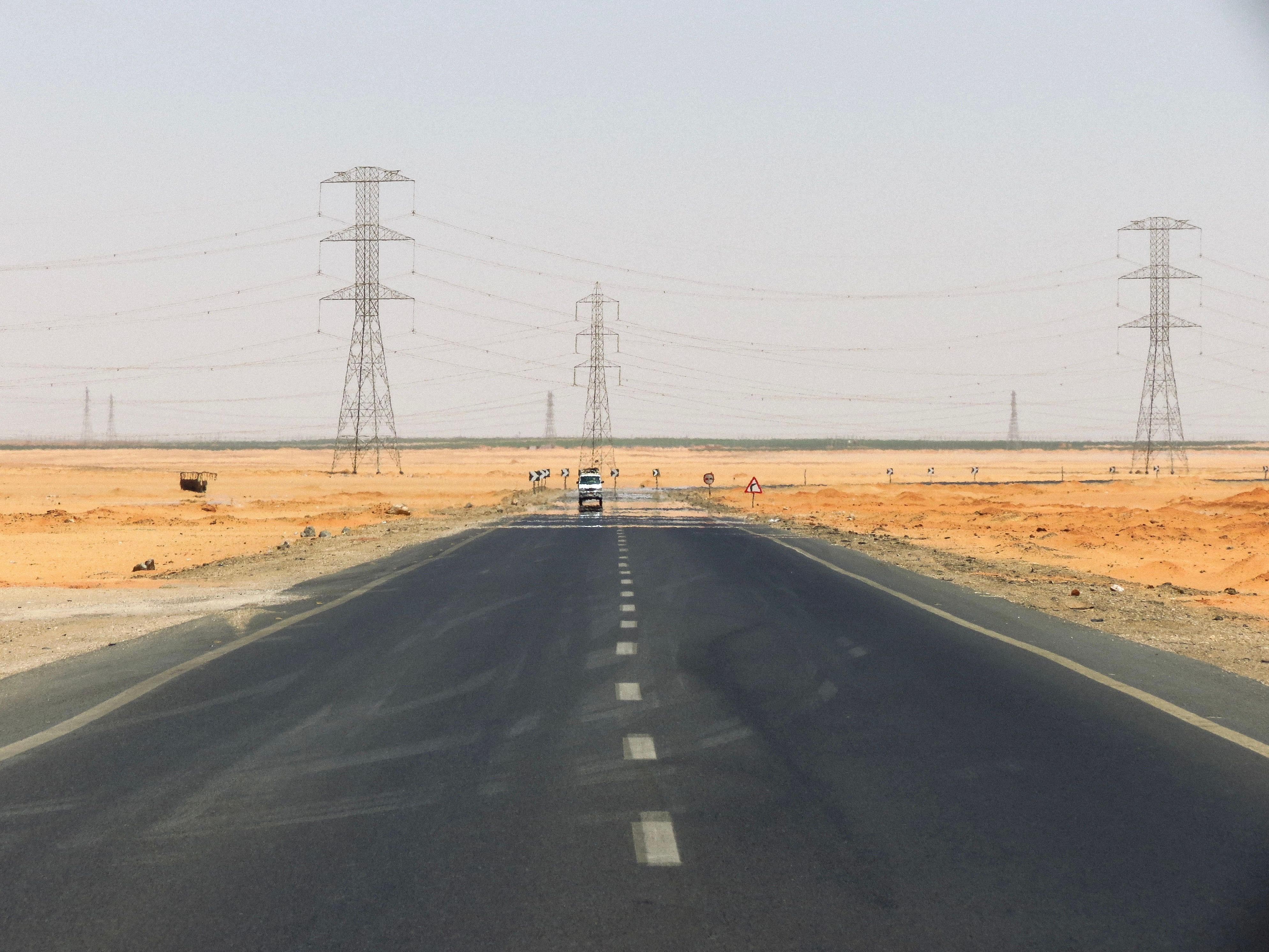 Power lines against a hazy sky during extreme heat