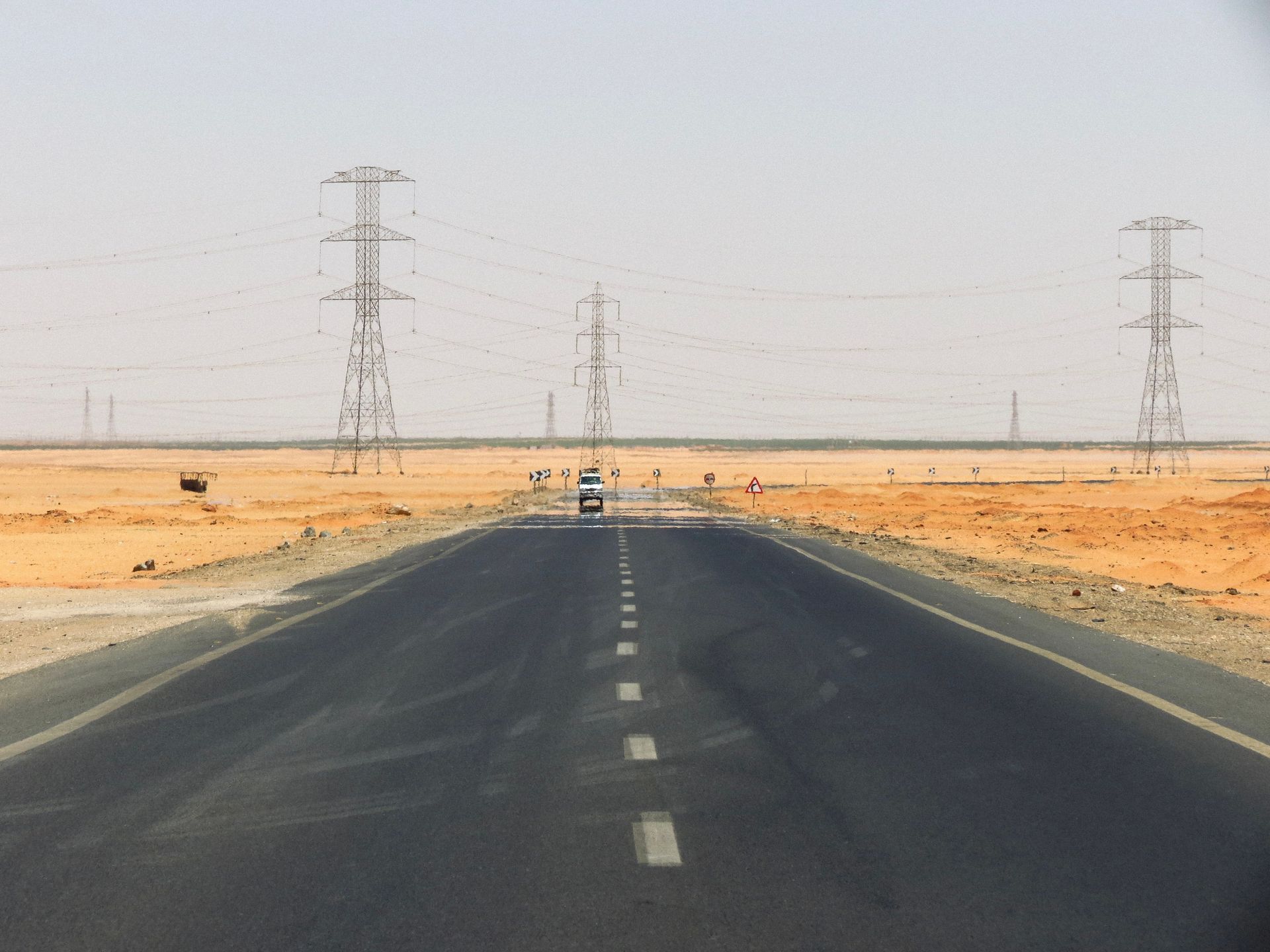 Power lines against a hazy sky during extreme heat