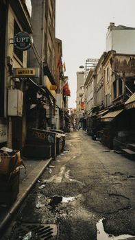A deserted city alleyway showcasing urban decay and old architecture.